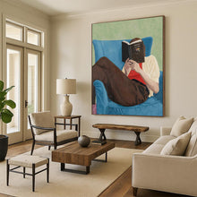Load image into Gallery viewer, “Bookish Retreat” ,Soft green background, blue armchair, brown pants, white and red clothing, with a figure reading a book. DTP303